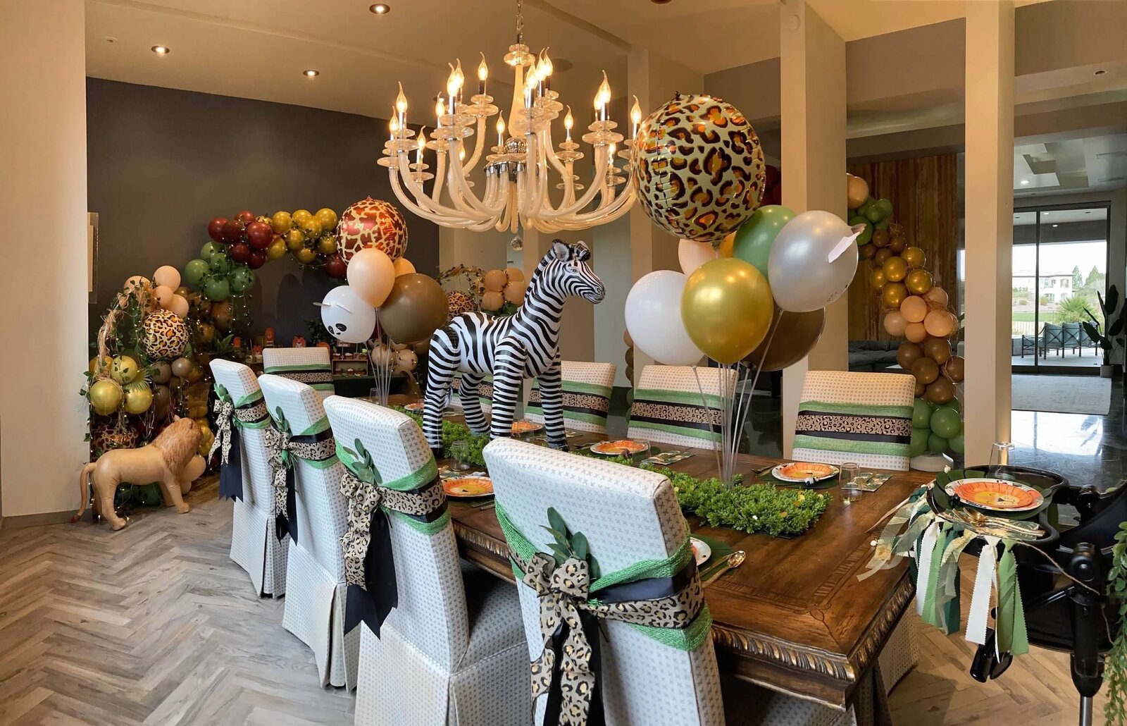 Safari-themed birthday tablescape with zebra centerpieces