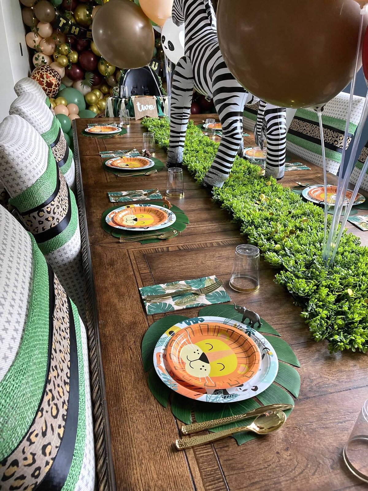 Jungle birthday tablescape detail with lion plates