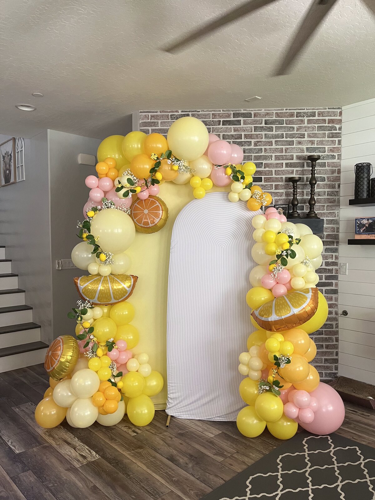 Custom citrus-themed balloon arch installation by Balloons by Rachel